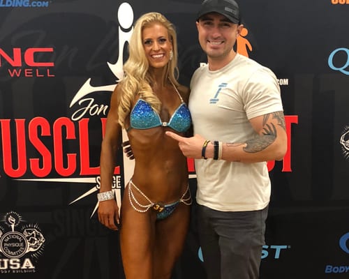 Trainer with client at fitness competition