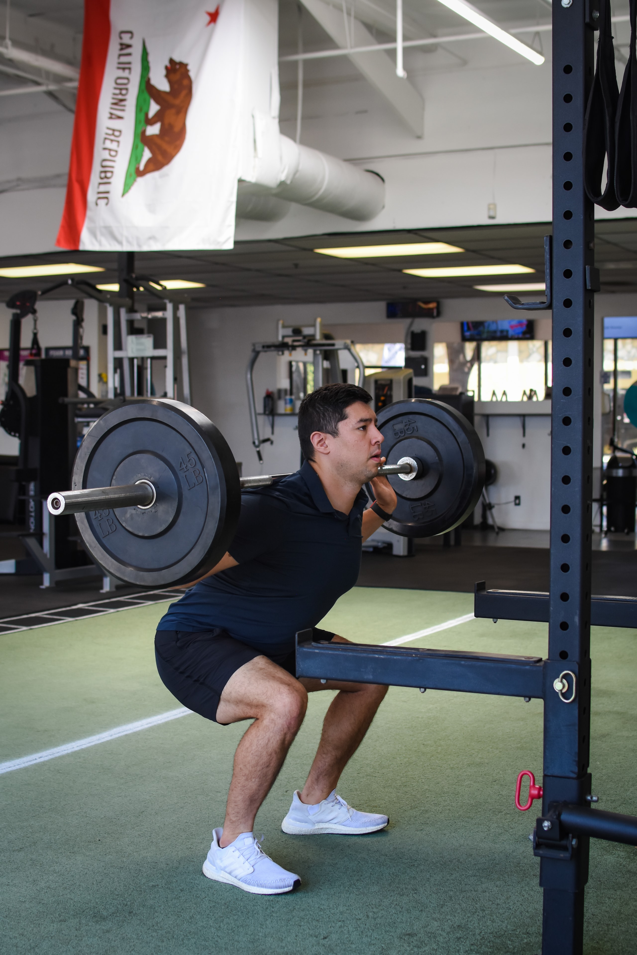 Rogue barbell loaded with plates at Symmetry Fitness Newport Beach