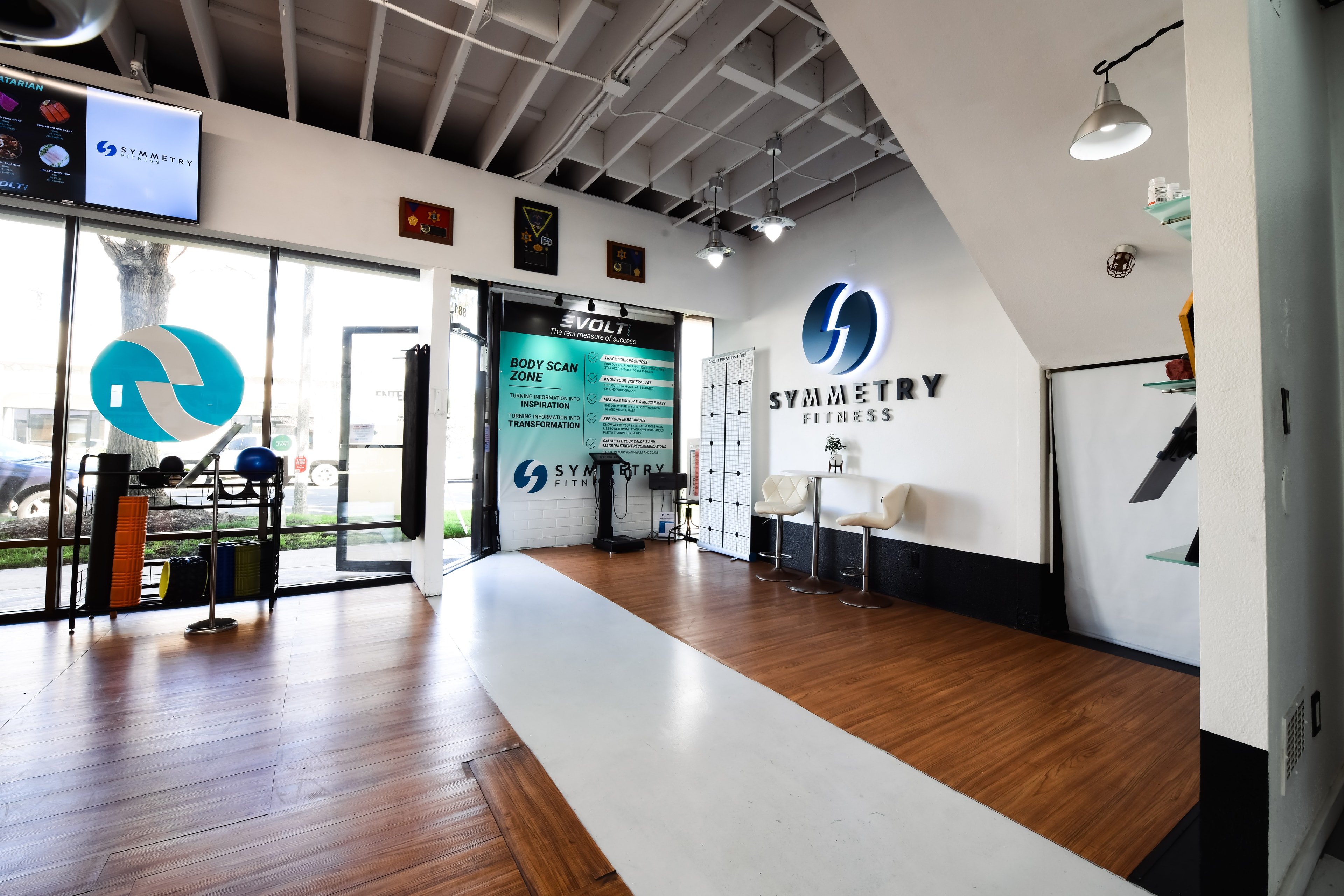 Rogue weight plates and barbell at Symmetry Fitness