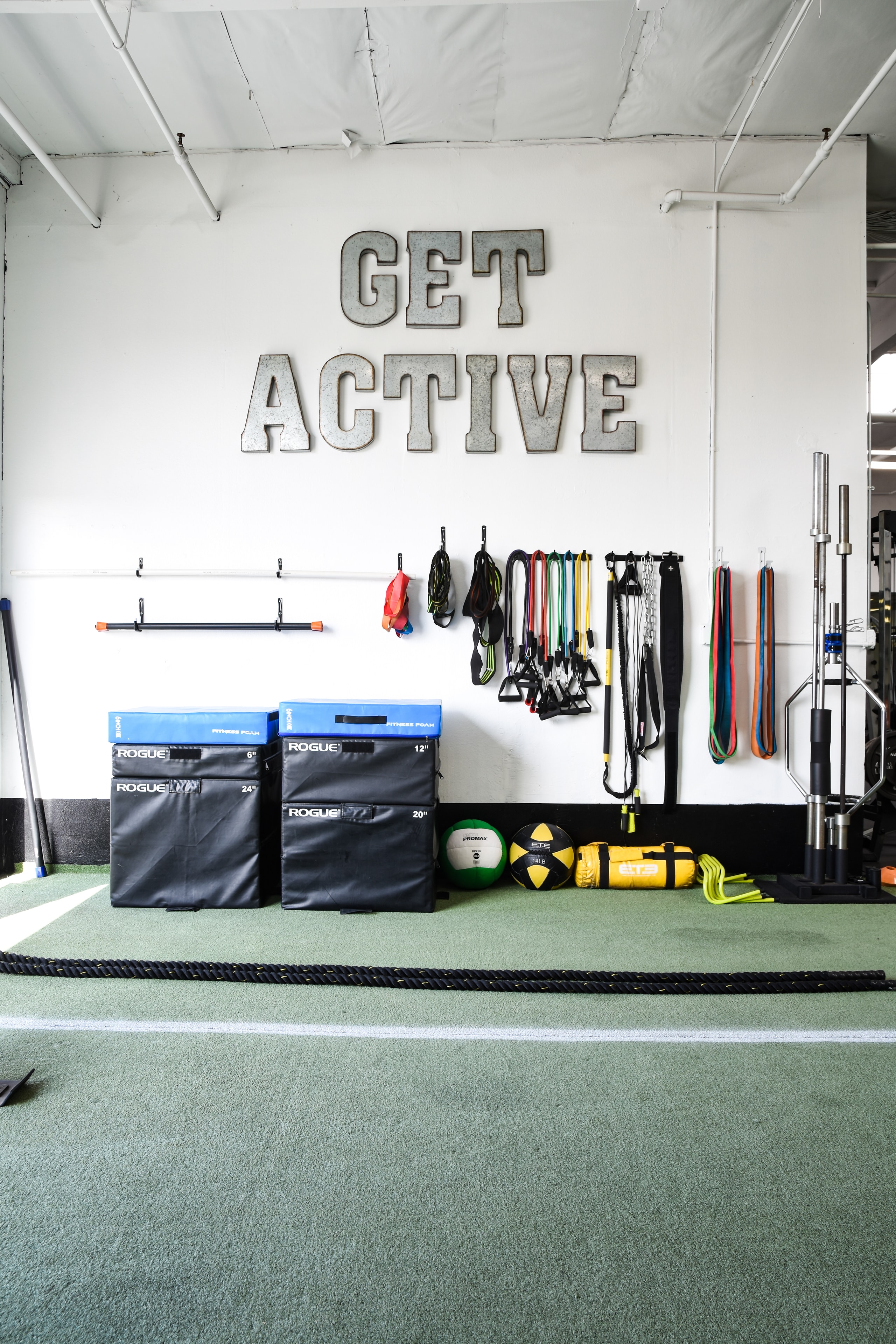 Symmetry Fitness gym floor with GET ACTIVE signage and training equipment